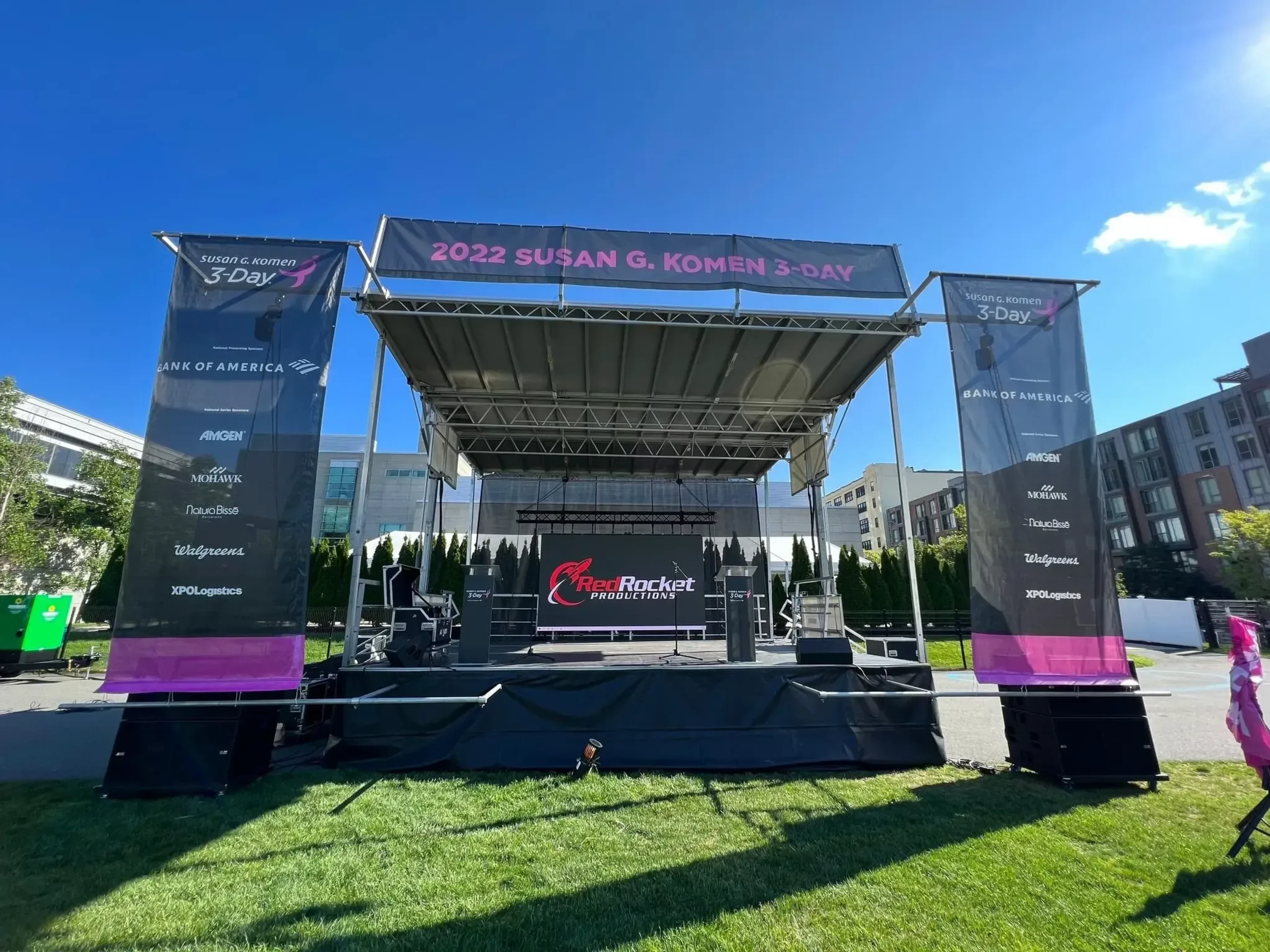 SL100 mobile stage front view with lighting and PA array