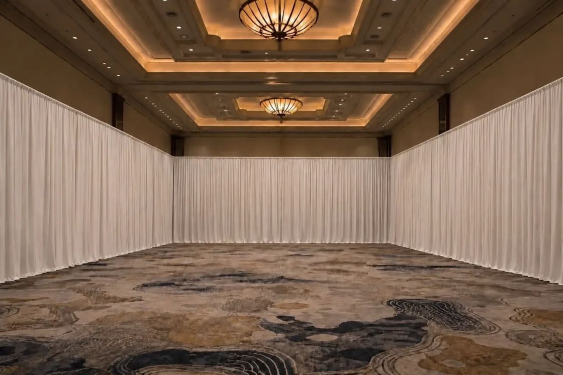 Full-height pipe and drape walls dividing and lining an Atlanta ballroom.
