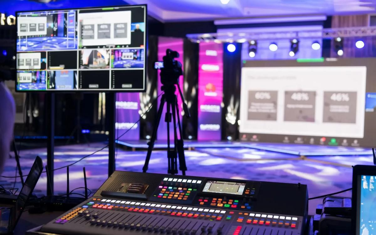 Hybrid corporate event setup with cameras and LED wall
