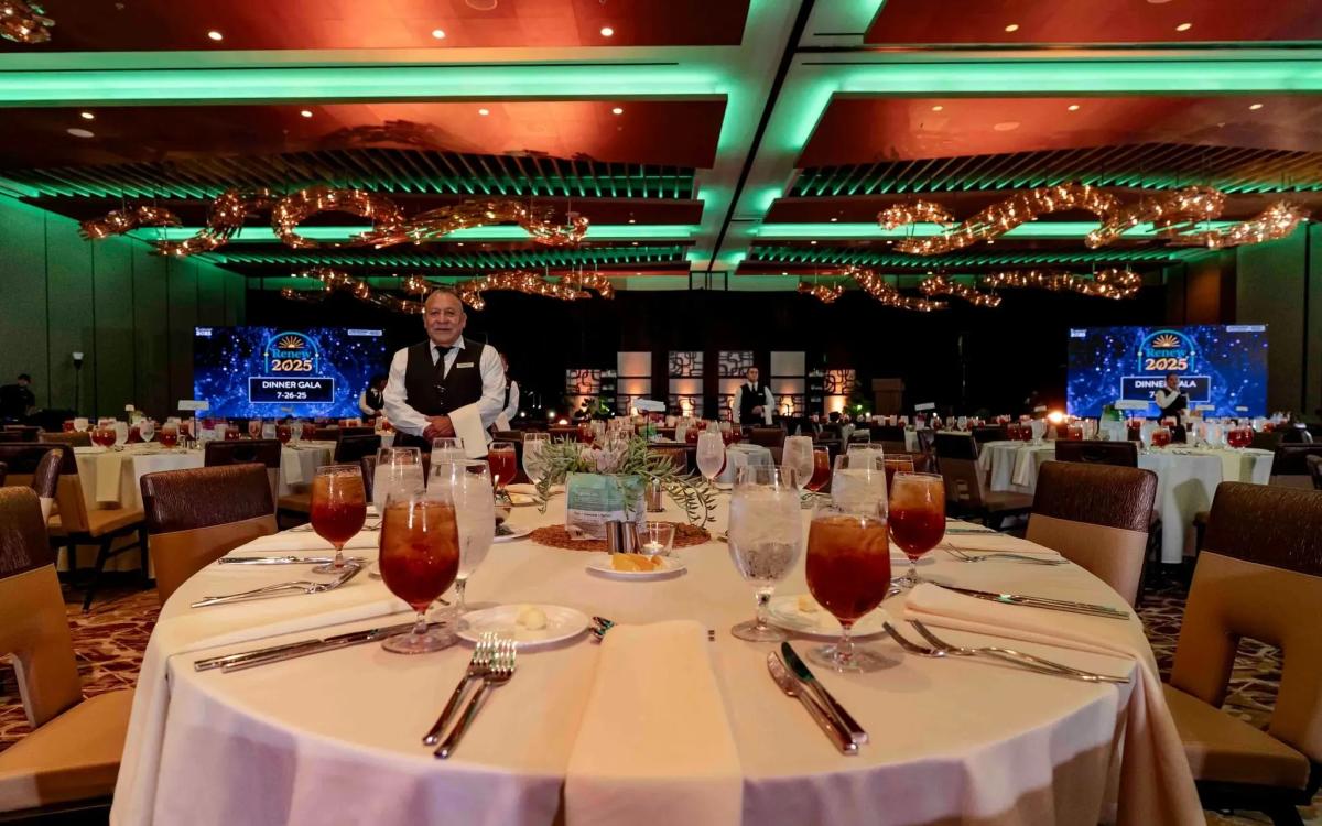 Corporate gala stage with theatrical lighting and LED backdrop