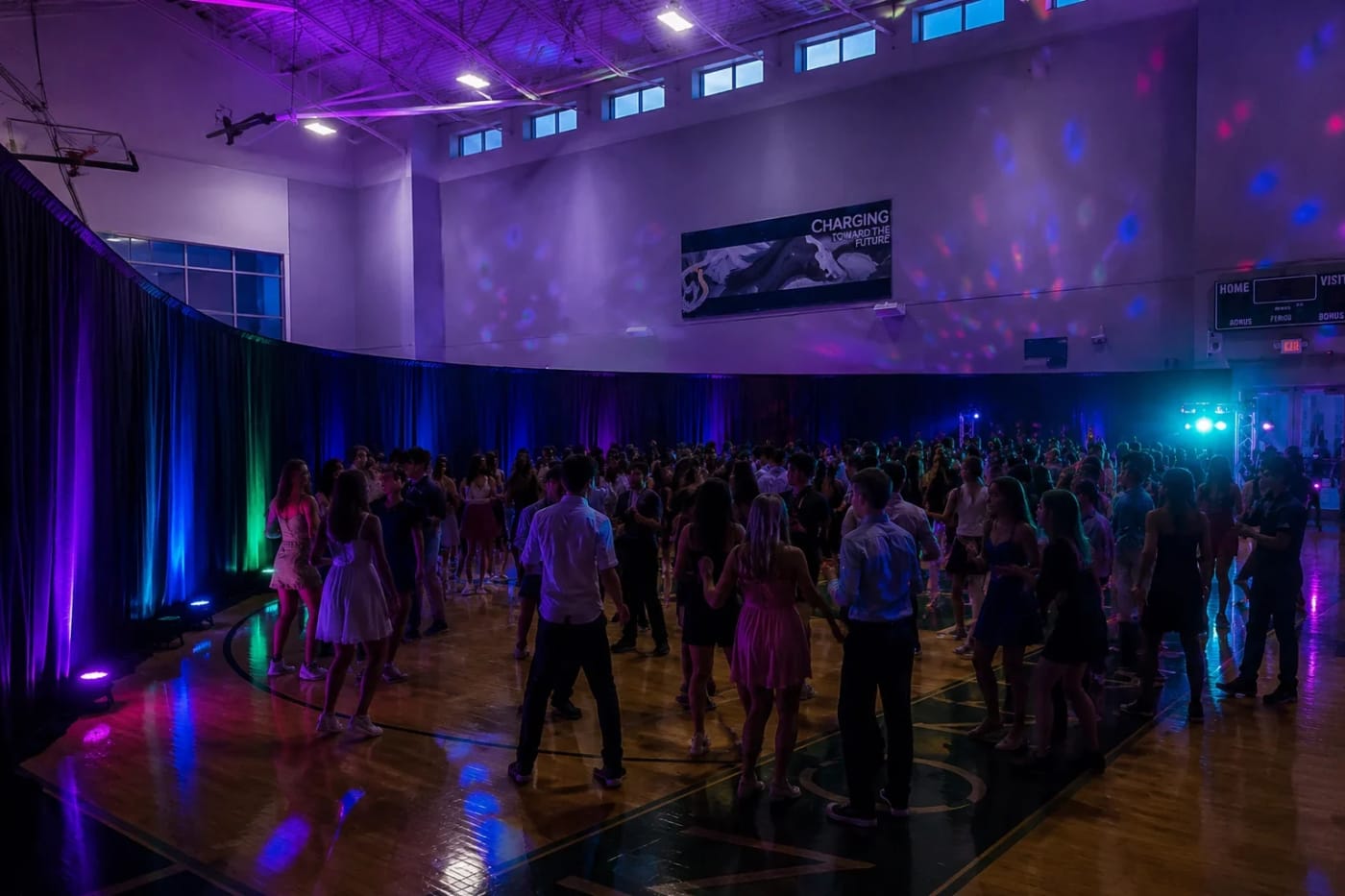 Black pipe and drape backdrop with adjustable uprights and crossbars dividing a large Atlanta event hall.