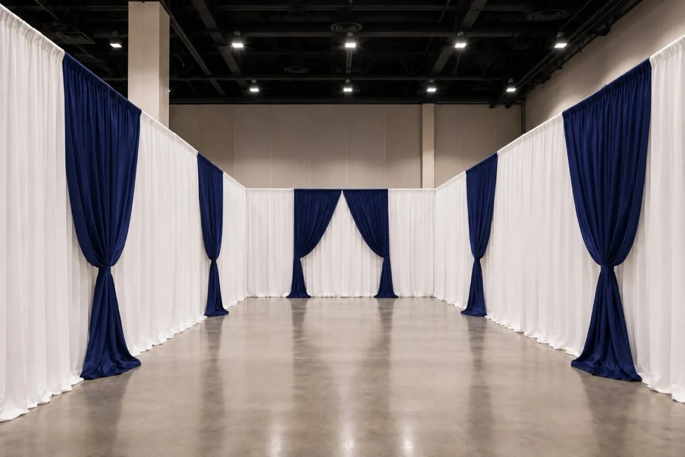 Clean white and navy pipe and drape backdrop walls installed in an Atlanta hall.