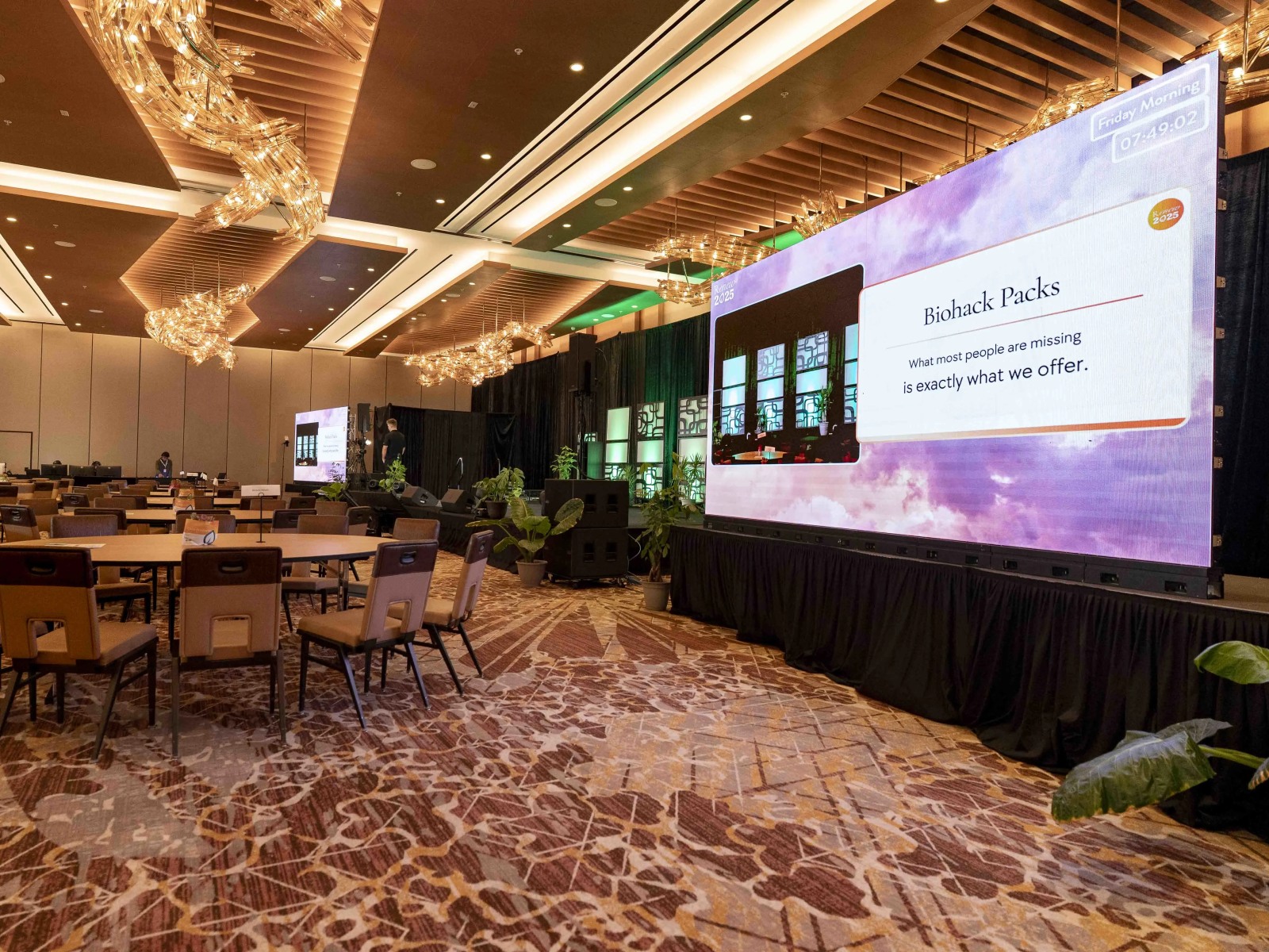 Wide LED video wall behind a general-session stage in an Atlanta ballroom