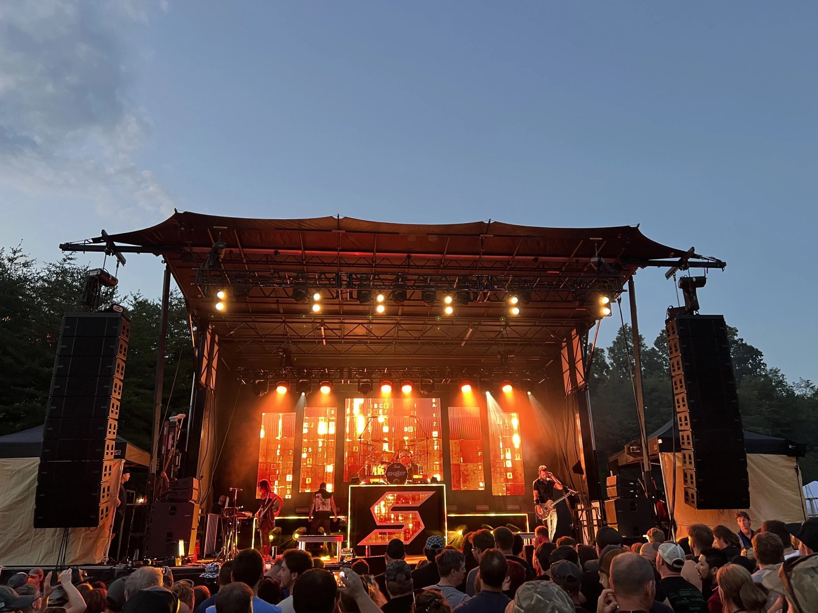 Outdoor stage with LED video wall, lighting, and audio at night