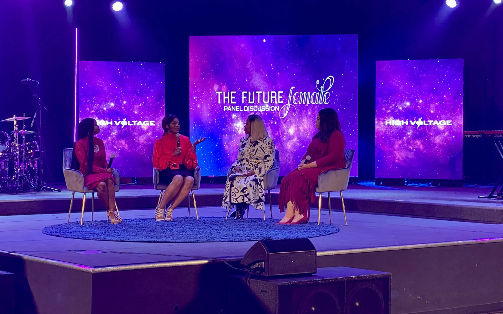 Ministry panel discussion with center LED wall and flanking screens on elevated stage
