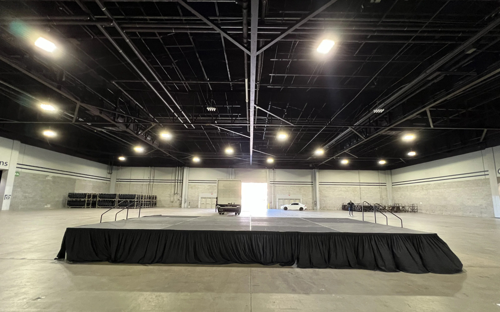 Tiered indoor staging with 4x8 deck platforms at corporate event