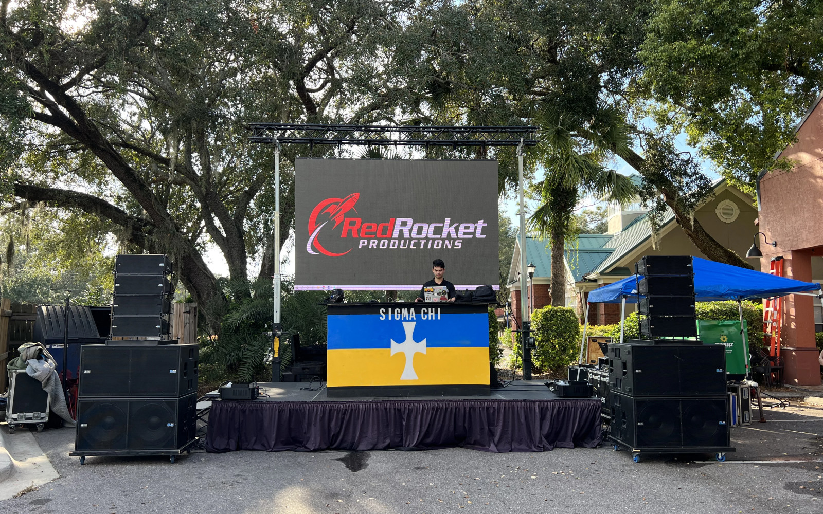 Ground support system with LED wall at outdoor festival stage daytime