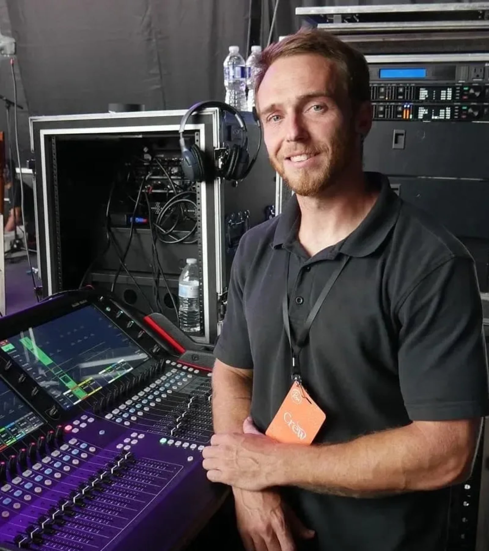 Production manager at console coordinating concert load-in