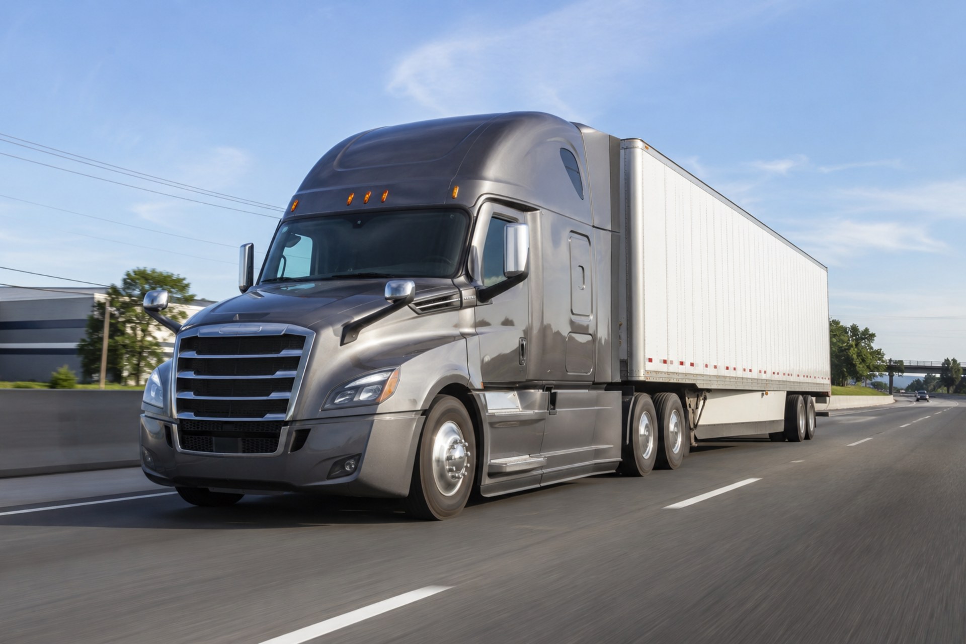 A tractor-trailer travelling a highway between a supplier and a jobsite