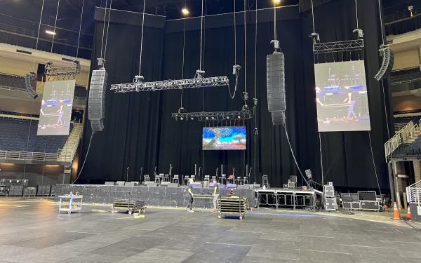 Arena concert production with full lighting and LED video walls