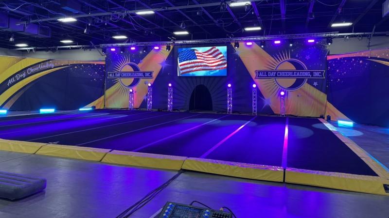 Central LED stage with light array for cheer competition