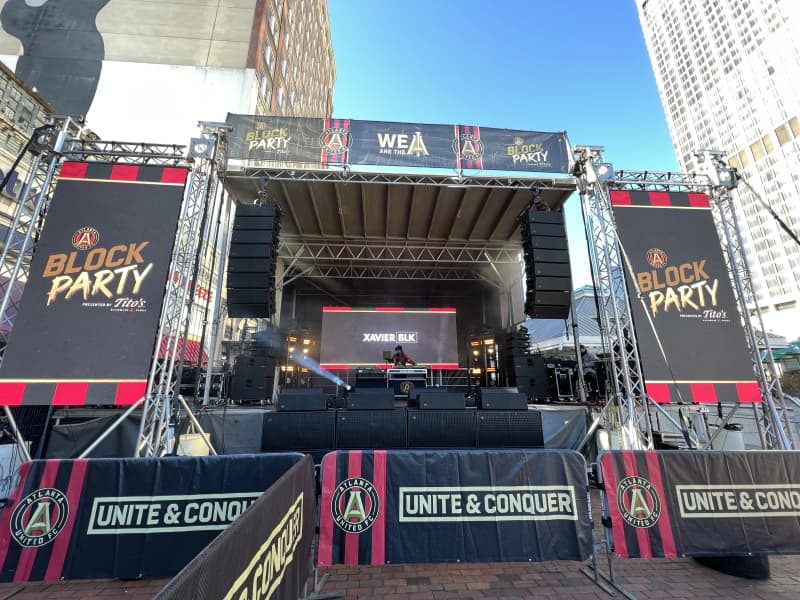 Atlanta United block party with outdoor stage and LED video wall near Mercedes-Benz Stadium