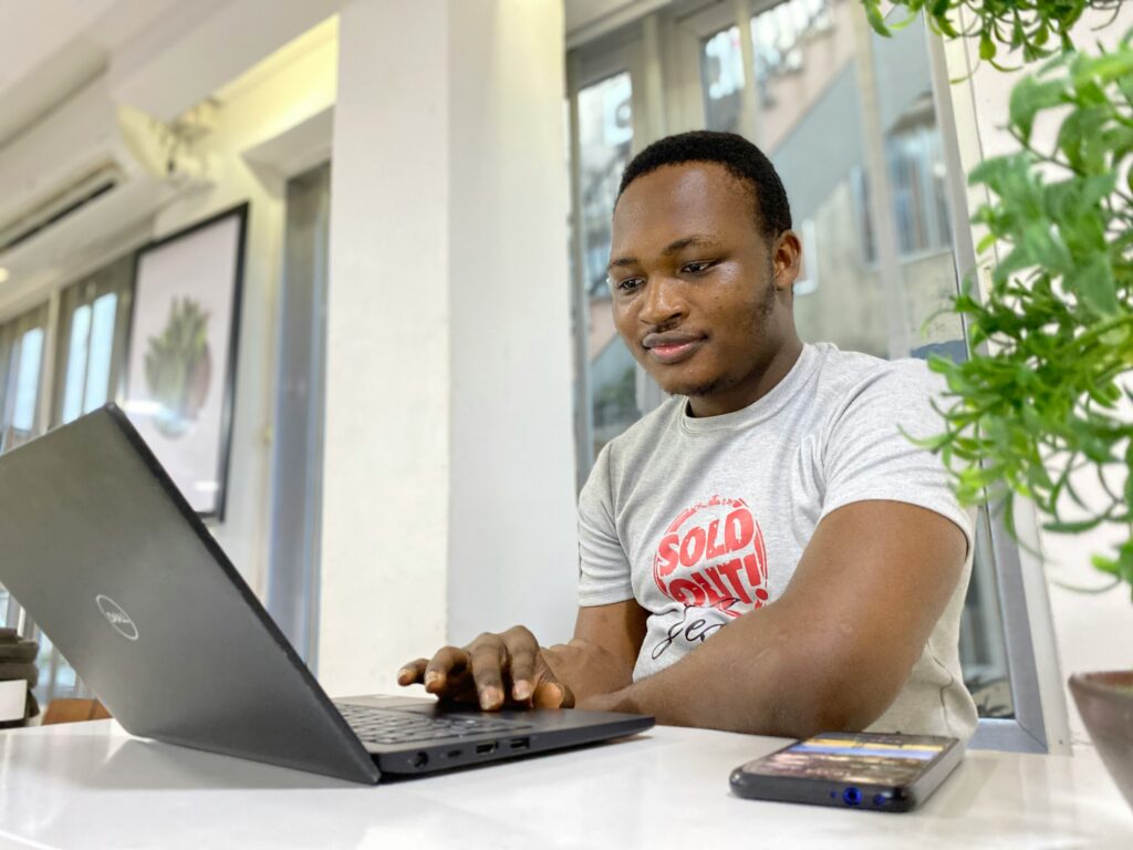 A young man googling how to make money online 