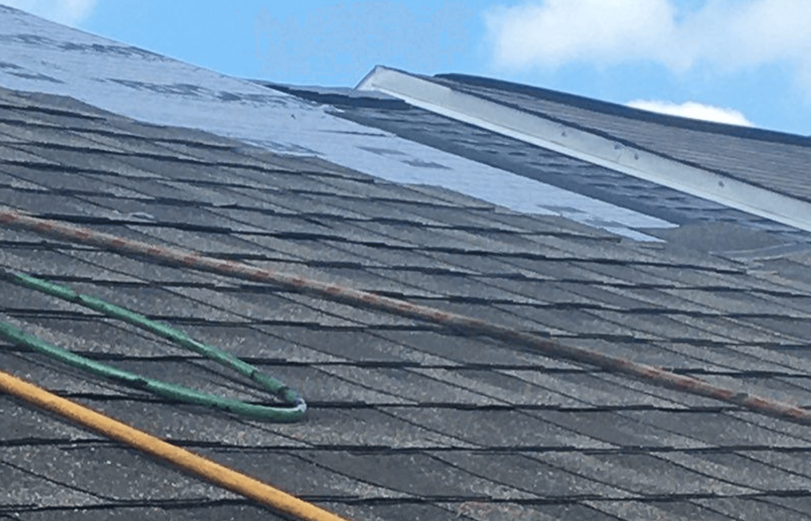 Roofsimple working on roof installing new roofing system for Charles Courtney