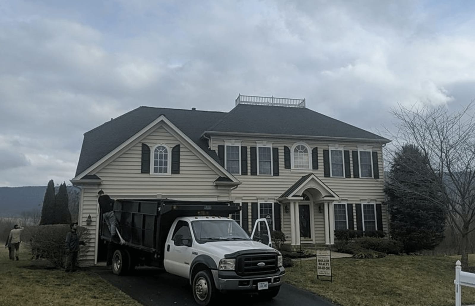 Roofsimple workers on roof installing new roofing system for Paul Blacet