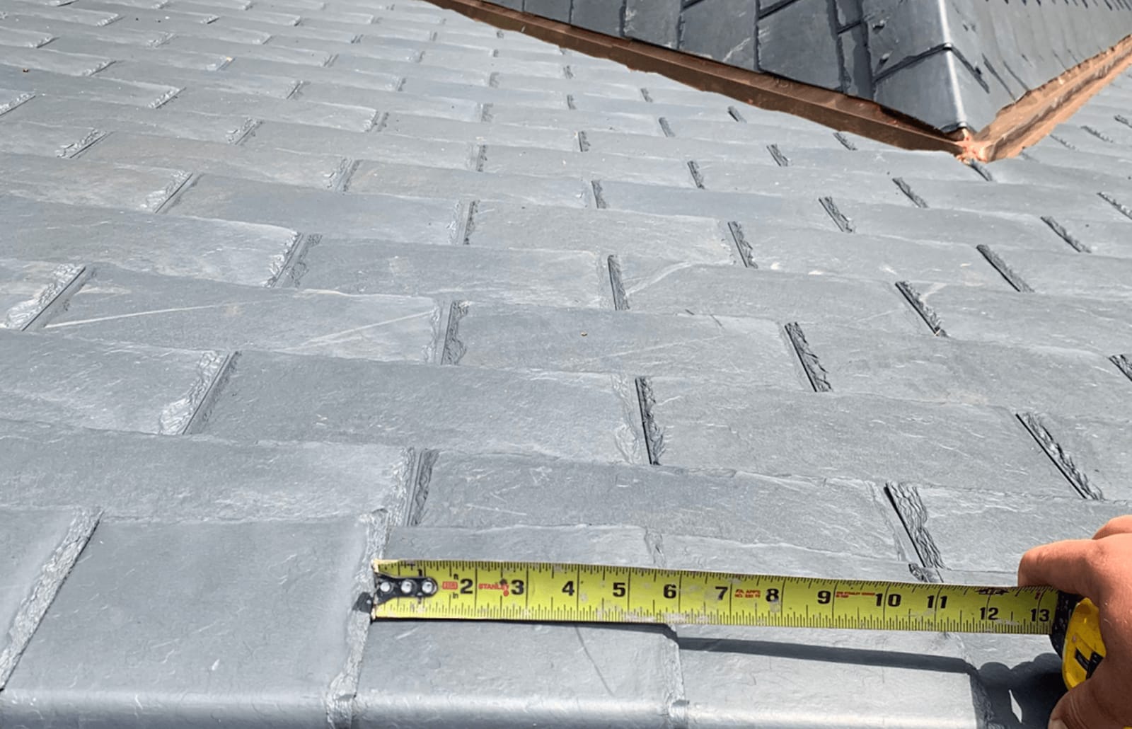 Roofsimple worker on roof installing new roofing system for Jing Feng