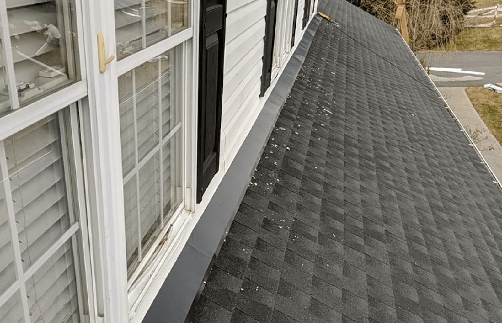 Roofsimple worker on roof installing new roofing system for Denise Plasters