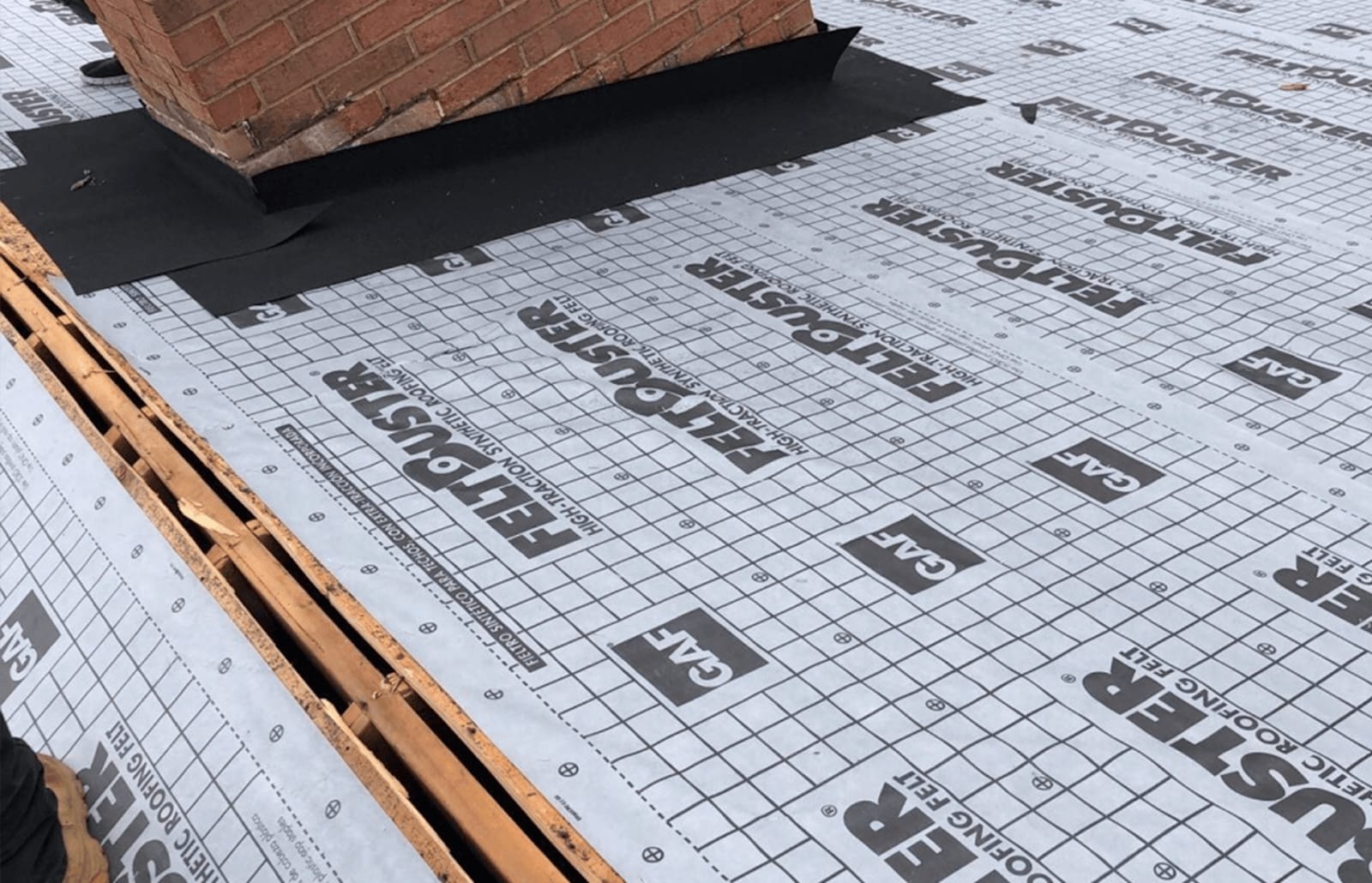 Roofsimple working on roof installing new roofing system for Mary Baldwin
