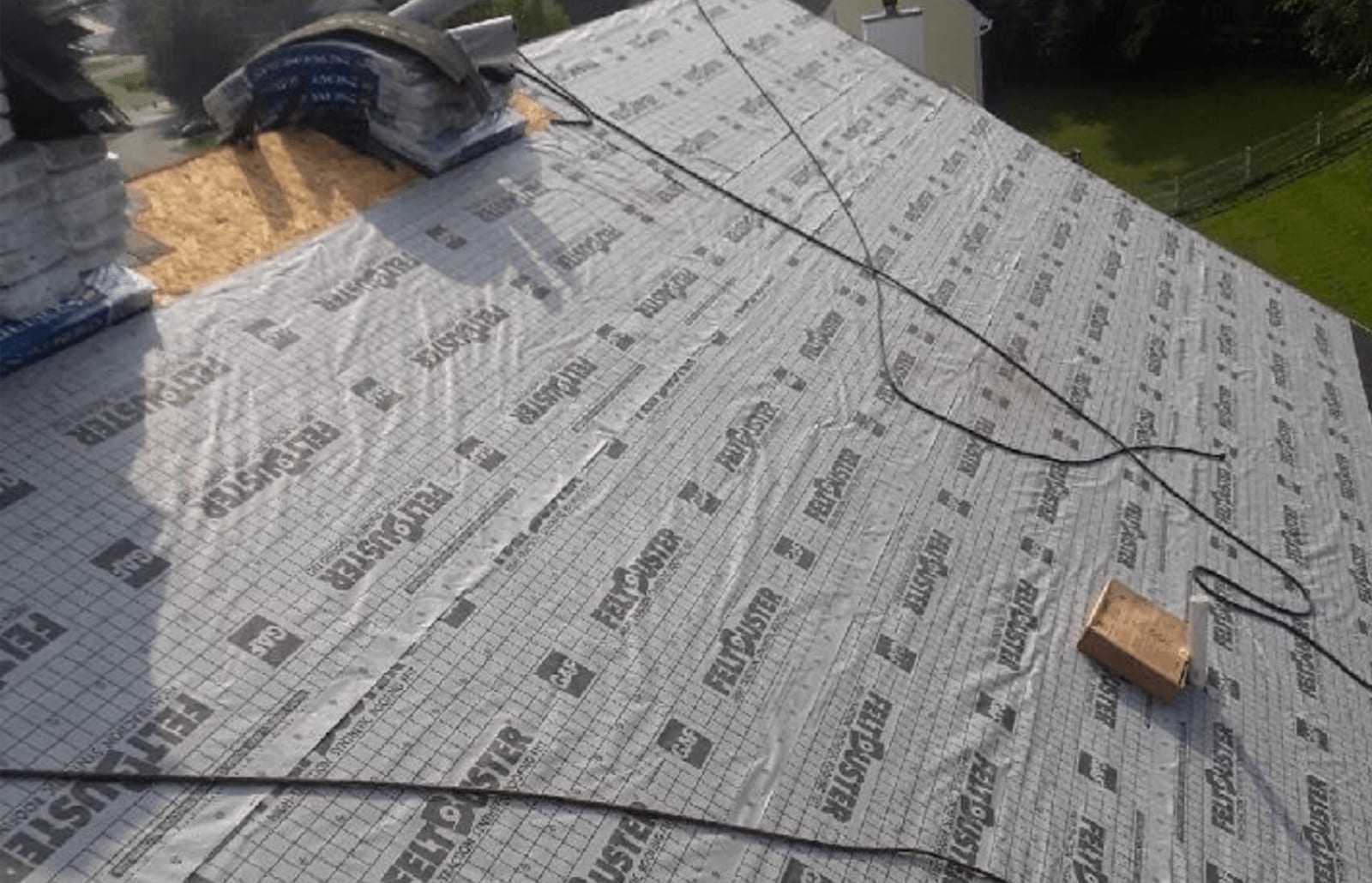 Roofsimple working on roof installing new roofing system for Ryan Wilharm