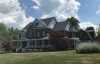 Roofsimple worker on roof installing new roofing system for Heather W