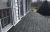 Roofsimple worker on roof installing new roofing system for Bruce L