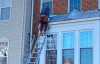 Roofsimple worker on roof installing new roofing system for John Sura
