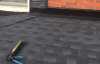 Roofsimple worker on roof installing new roofing system for Jennifer Coker