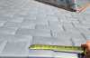 Roofsimple worker on roof installing new roofing system for Jing Feng