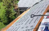Roofsimple working on roof installing new roofing system for Frank Simon