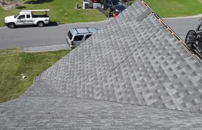 Roofsimple worker on roof installing new roofing system for M. Shankle