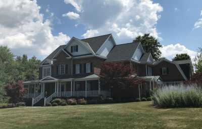 Roofsimple worker on roof installing new roofing system for Heather W
