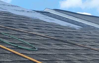 Roofsimple working on roof installing new roofing system for Charles Courtney