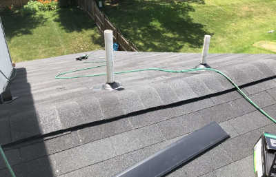 Roofsimple worker on roof installing new roofing system for Edward Hillyard