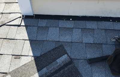 Roofsimple worker on roof installing new roofing system for David Boyd
