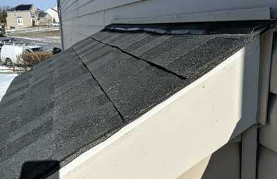 Roofsimple worker on roof installing new roofing system for Charles Gilbert 