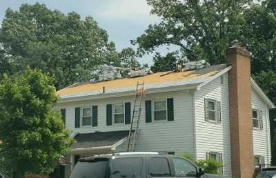 Roofsimple workers on roof installing new roofing system for Elizabeth Schloemer