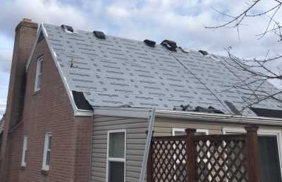 Roofsimple working on roof installing new roofing system for Amanda Graf