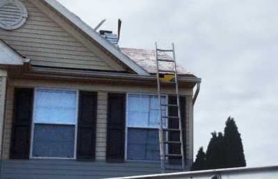 Roofsimple working on roof installing new roofing system for Jamie Giza