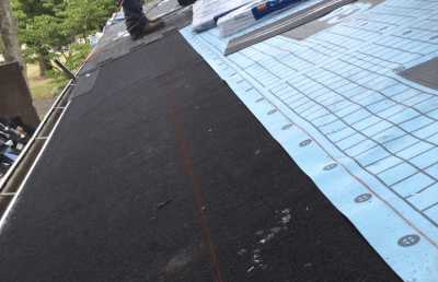 Roofsimple working on roof installing new roofing system for John McClain