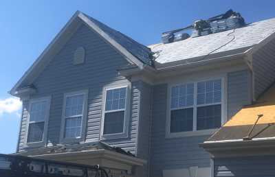 Roofsimple working on roof installing new roofing system for Ron Kelly