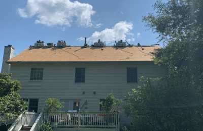 Roofsimple working on roof installing new roofing system for Herbert Williams
