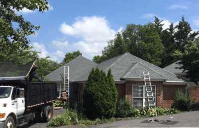 Roofsimple working on roof installing new roofing system for Judy Fogle