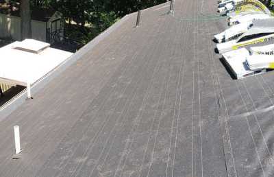 Roofsimple working on roof installing new roofing system for Regi Payne