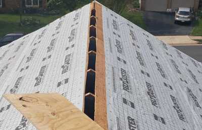 Roofsimple working on roof installing new roofing system for Umit Gurunlu 