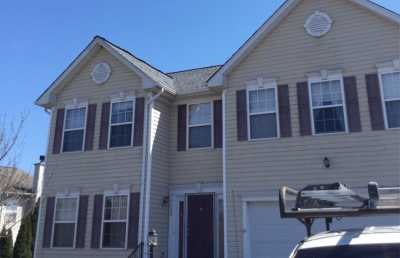 Roofsimple working on roof installing new roofing system for Qi Chen
