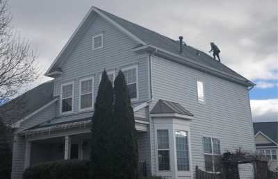 Roofsimple worker installing new roofing system for Timothy Hardman