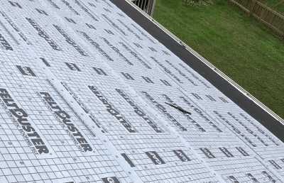 Roofsimple working on roof installing new roofing system for Ken Cooper