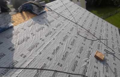 Roofsimple working on roof installing new roofing system for Ryan Wilharm