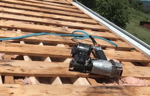 roofer discussing roof replacement cost with homeowner