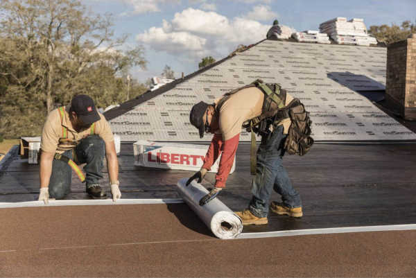 Local roofing company installing a new roof system